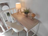a wooden desk with a lamp and a white chair at Chill Out Cabanon Coeur Calanques in Marseille