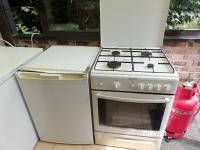 a kitchen with a stove and a refrigerator at Calme de la campagne in Le Torp-Mesnil