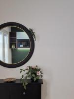 a mirror on a wall next to a table with a plant at maison PING ,en face des arènes in Béziers