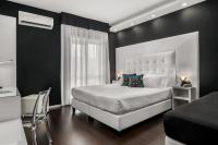 a bedroom with a white bed and a black wall at Reggia Suite Spa Hotel in Caserta