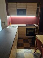 a kitchen with a counter with a sink and a stove at maison PING ,en face des arènes in Béziers