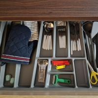 a drawer filled with utensils in a cabinet at maison PING ,en face des arènes in Béziers