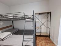 a room with two bunk beds and a ladder at maison PING ,en face des arènes in Béziers