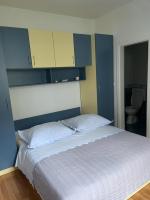 a bedroom with a large bed with blue and yellow cabinets at Apartment Lucy in Makarska