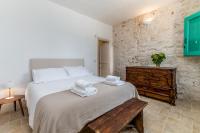 A bed or beds in a room at Masseria Bel Cortile - Ostuni