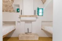 A bed or beds in a room at Masseria Bel Cortile - Ostuni
