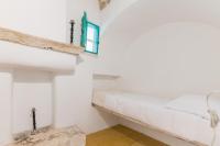 A bed or beds in a room at Masseria Bel Cortile - Ostuni