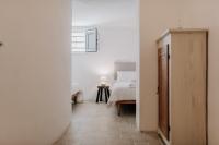 A bed or beds in a room at Masseria Bel Cortile - Ostuni