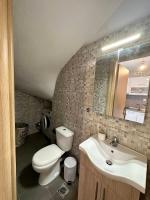 a bathroom with a toilet and a sink and a mirror at ENDLESS BLUE Dream Villa in Paleo Tsifliki