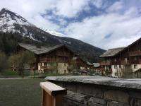 a group of buildings with a mountain in the background at HaKaJu Appartement 10 personnes à Val Cenis in Lanslebourg-Mont-Cenis