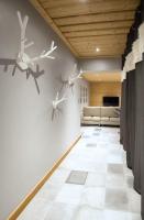 a living room with white tile floors and birds on the wall at HaKaJu Appartement 10 personnes à Val Cenis in Lanslebourg-Mont-Cenis