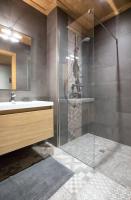 a bathroom with a glass shower and a sink at HaKaJu Appartement 10 personnes à Val Cenis in Lanslebourg-Mont-Cenis
