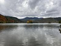 a large body of water with mountains in the background at Maison de Varennes in Chambon-sur-Lac