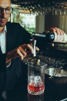 a man pouring a bottle of wine into a glass at Estalagem Santa Iria Hotel & Spa in Tomar