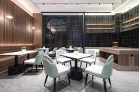 a restaurant with tables and chairs in a room at Morninginn,Puji in Liuyang