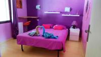 a pink bedroom with a bed with two stuffed animals on it at Villa de 2 chambres avec piscine privee jardin clos et wifi a Merindol in Mérindol