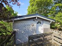 a smallshed with a white door and a fence at Au Refuge Des 3 Ours - Chambres d&#39;hôtes et cabanes in Essuiles-Saint-Rimault