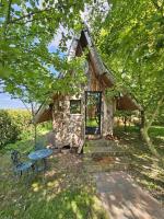 a log cabin with a table and chairs in front of it at Au Refuge Des 3 Ours - Chambres d&#39;hôtes et cabanes in Essuiles-Saint-Rimault