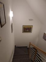 a staircase with a light and a picture on the wall at Guest house Wolf II in Plitvička Jezera