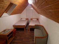 a small room with two beds and a table at Guest house Wolf II in Plitvička Jezera