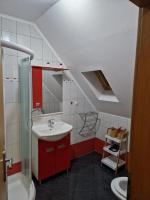 a bathroom with a sink and a red cabinet at Guest house Wolf II in Plitvička Jezera