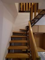 a staircase in a house with wooden steps at Guest house Wolf II in Plitvička Jezera