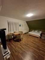 a bedroom with a bed and a table and chairs at Guest house Wolf II in Plitvička Jezera