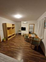 a living room with a table and chairs and a television at Guest house Wolf II in Plitvička Jezera