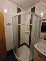 a shower in a bathroom with a glass door at Guest house Wolf II in Plitvička Jezera