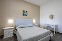 A bed or beds in a room at La Perla Di Mare - Gemma