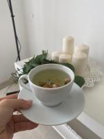 a person holding a cup of soup on a plate at Serenity Apart in Antalya