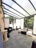 a screened in patio with chairs and tables at Villa de 2 chambres avec piscine privee jardin clos et wifi a Merindol in Mérindol