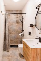 a bathroom with a shower and a toilet and a sink at Panorama Górska Wisła Resort & SPA in Wisła