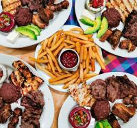 a table topped with plates of food with french fries at Los Almendros de San Lorenzo in Suchitoto