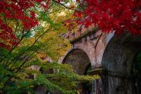 a brick bridge with red leaves on the trees at Tokyu Stay Kyoto Sanjo-Karasuma in Kyoto