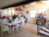 a kitchen with a table and chairs in a room at Gite des amis Domaine de Mas Caron in Caromb