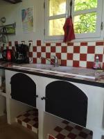 a kitchen with a sink and a checkered counter top at Gite des amis Domaine de Mas Caron in Caromb