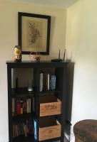a black book shelf with boxes of books at Gite des amis Domaine de Mas Caron in Caromb