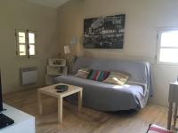 a living room with a couch and a table at Gite des amis Domaine de Mas Caron in Caromb