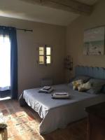 a bedroom with a bed with two towels on it at Gite des amis Domaine de Mas Caron in Caromb