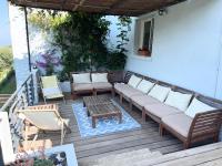 a patio with a couch and a table and chairs at Casa Costa in Barbaggio