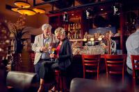 a group of people standing at a bar at Adorable two bedroom bungalow C7 next to hotel. in Garderen