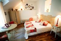 a bedroom with a bed and a table and a table at Gîte de la corgette in Saint-Romain