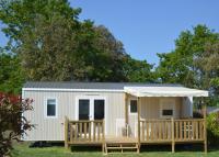 a tiny house with a porch and a gazebo at Mobil home neuf en Bretagne sud in Guérande