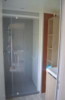 a bathroom with a shower with a glass door at Mobil home neuf en Bretagne sud in Guérande
