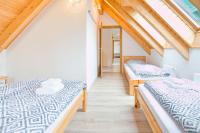 Łóżko lub łóżka w pokoju w obiekcie Apartmán Riviéra Lipno 510/21