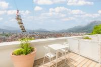 a balcony with a table and chairs and a view at Les Appartements de Grenoble in Grenoble