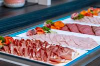 a table with different types of meats and vegetables at AHORN Berghotel Friedrichroda in Friedrichroda