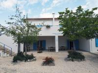 a white building with trees and flowers in front of it at Auberge des Plaines - Appartements avec terrasse in Arles