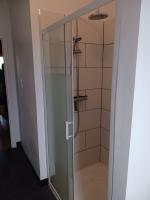 a shower with a glass door in a bathroom at La Casa in Saint-Brieuc